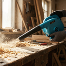 KATSU 550W electric leaf blower in use clearing wood dust in workshop