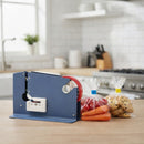 Kitchen scene with a plastic bag neck sealer on a counter, surrounded by sealed bags of vegetables and snacks.